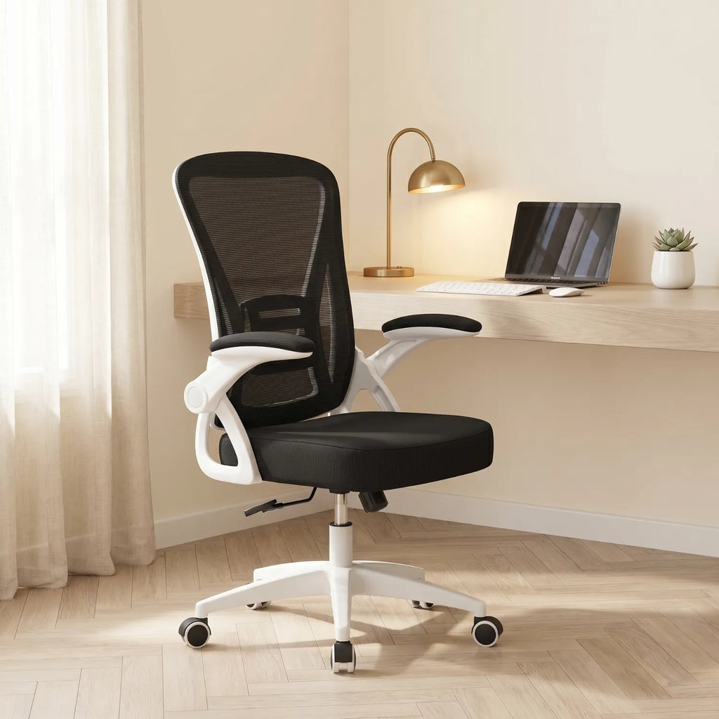 District 12 chaise ergonomique mesh noire positionnée devant un bureau en bois avec lampe dorée et laptop, home office lumineux tons chauds
